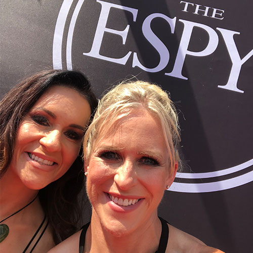nicole and a woman friend in front of the espy sign
